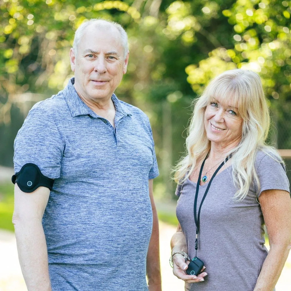 Two seniors standing next to each other with Latitude Mobile Alerts